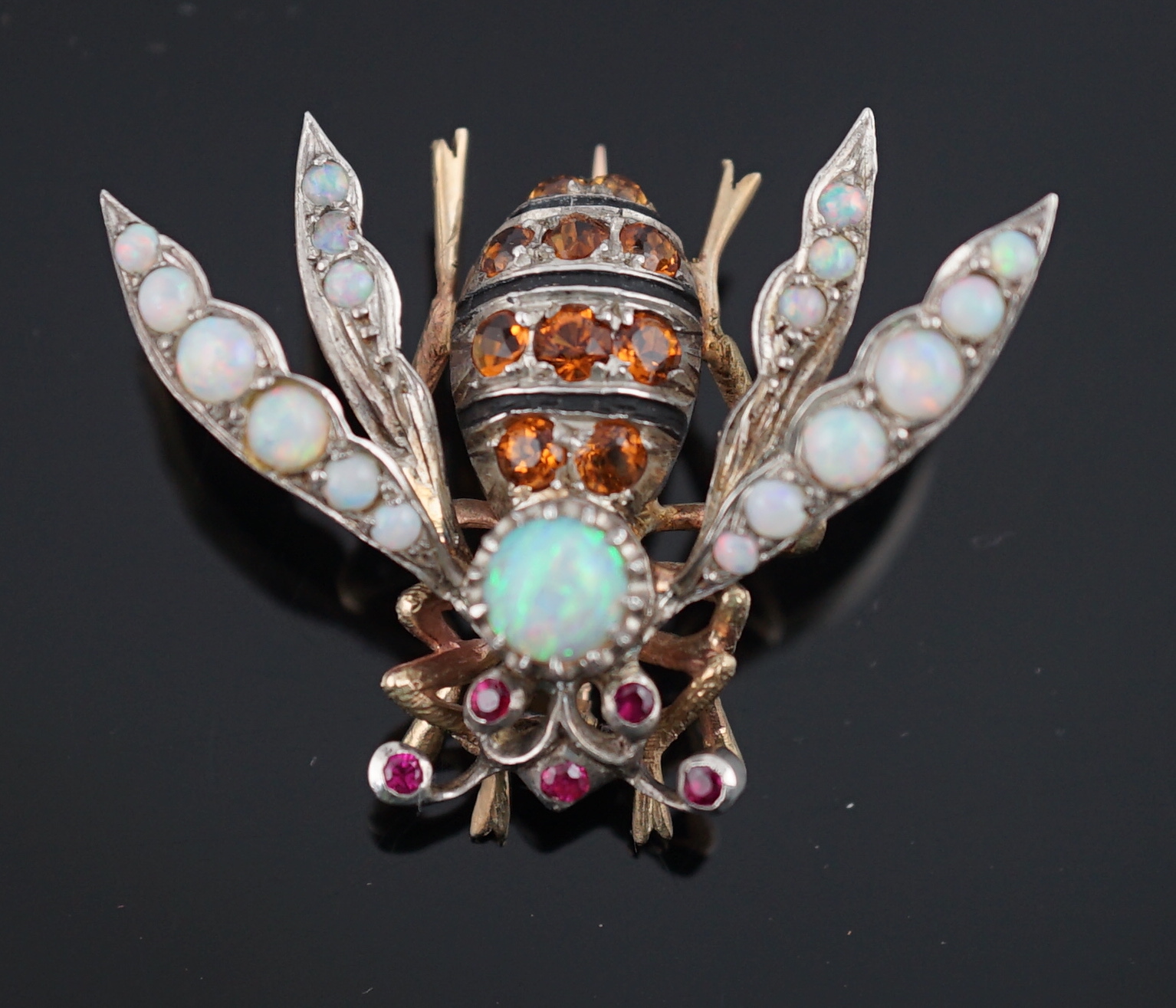 A late Victorian gold and silver, white opal, ruby and citrine? cluster set bug brooch